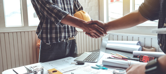 Contractor and customer shaking hands in office