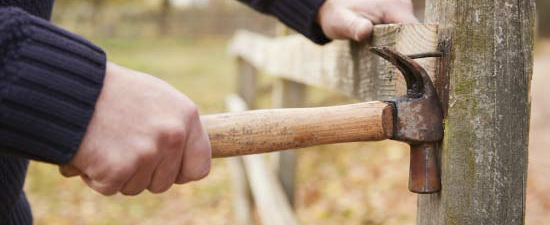 dismantling a wooden fence