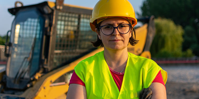 contractor standing in front of backhoe