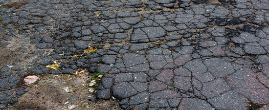 old and damaged asphalt driveway