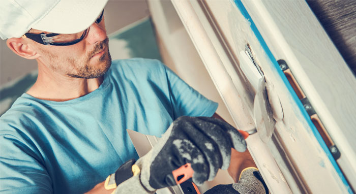 contractor repairing basement door frame