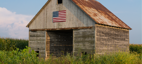 old wood barn in field