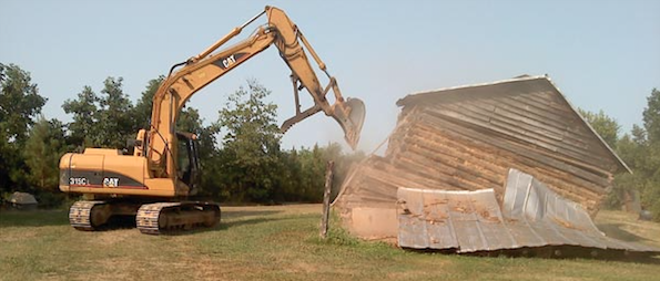 Barn demolition performed with an excavator