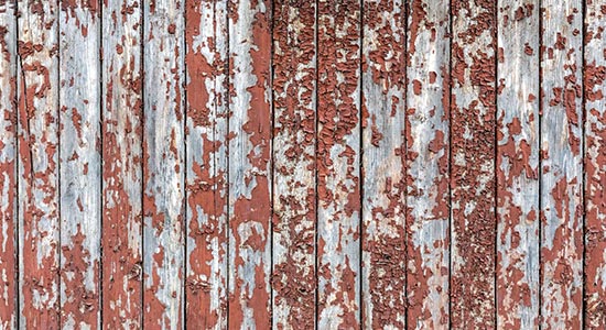 paint peeling on wooden fence