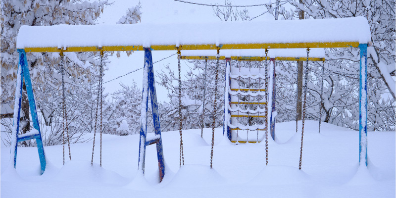 backyard playground covered with snow