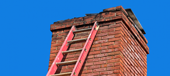 decaying chimney with ladder leaned against it