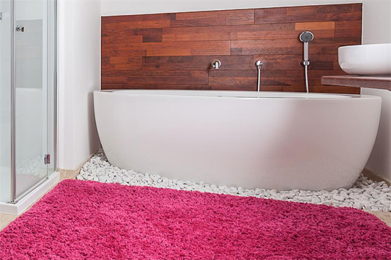 large pink fluffy throw rug in bathroom