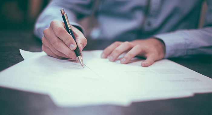 person signing a contract