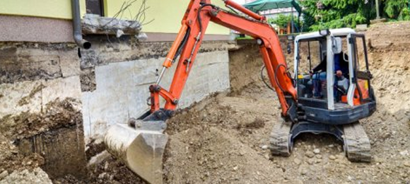 excavator tearing down house