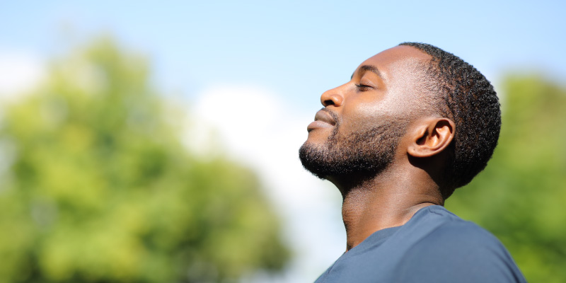 man smiling to himself while thinking