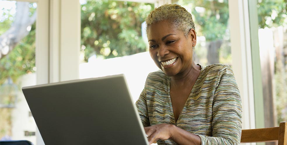 woman using laptop to read reviews