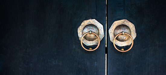 old tarnished handles on wooden cabinet doors