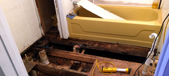 floor ripped up in old bathroom