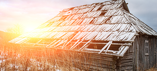 old dilapidated barn with holes in roof