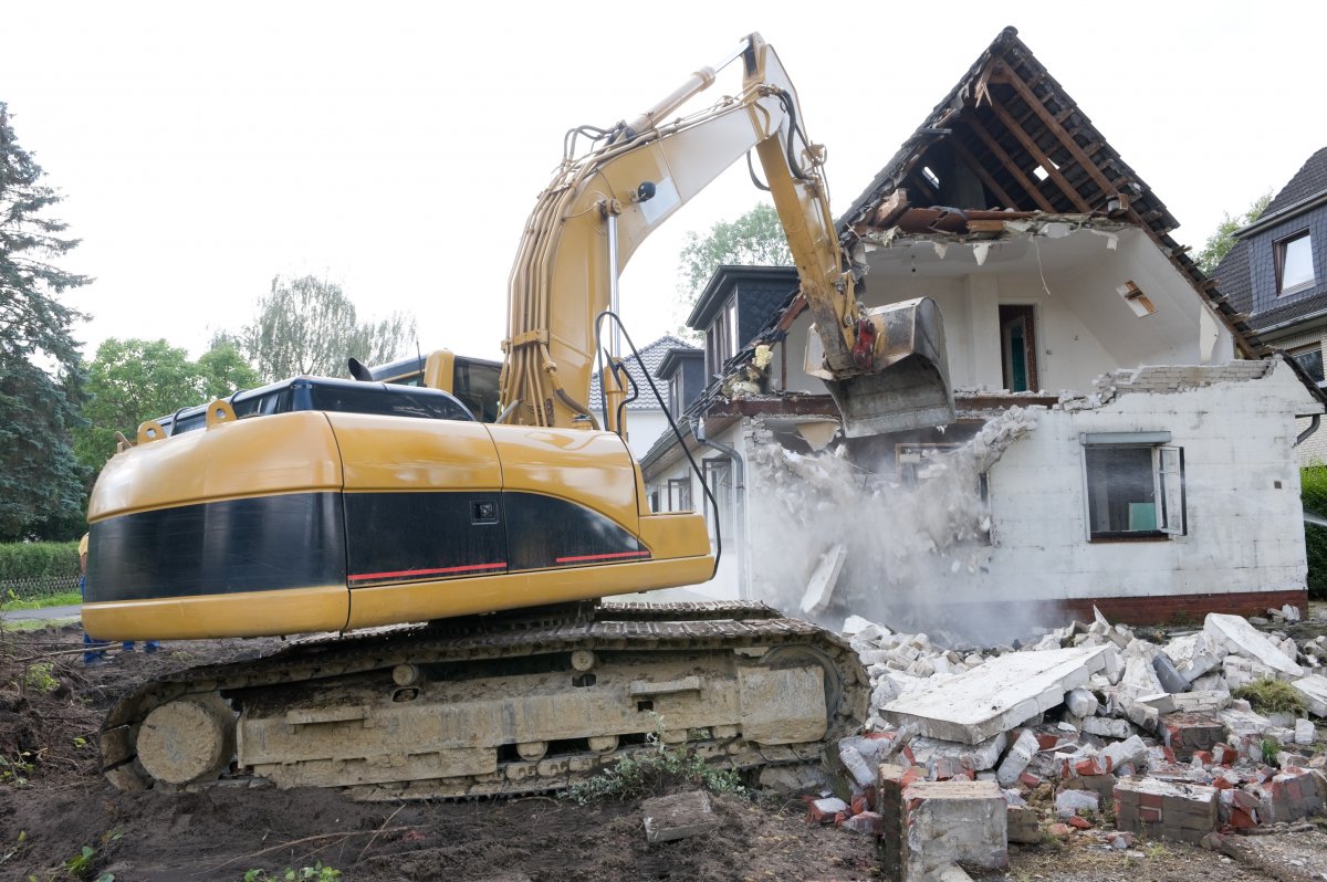 House is demolished using an excavator