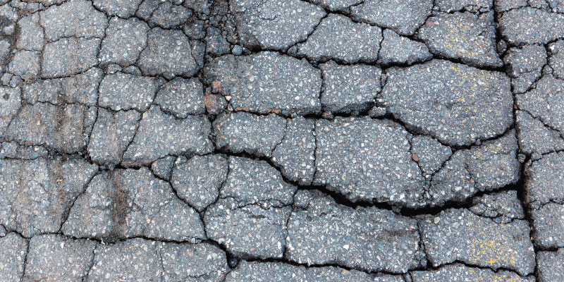deep cracks in asphalt parking lot