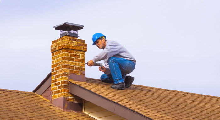 worker repairing chimney