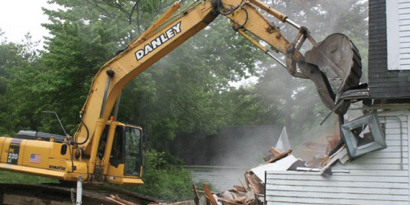 traditional mechanical demolition of a house
