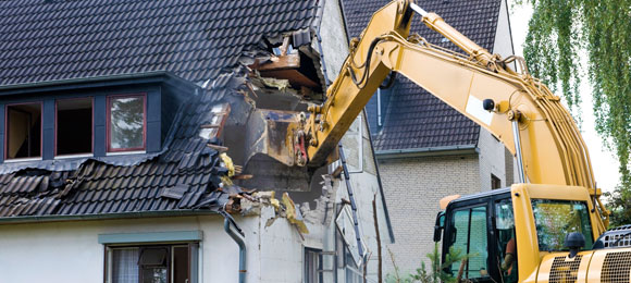 excavator tearing down house
