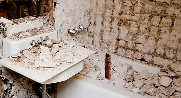 bathroom covered with demolition debris