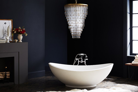 chandelier lighting fixture above modern bathtub
